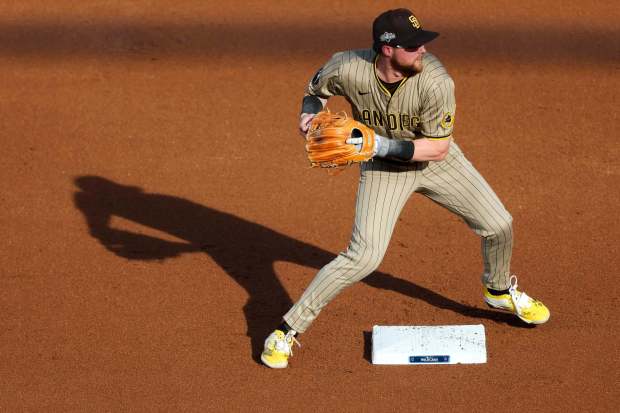 Jake Cronenworth #9 of the San Diego Padres attempts to turn a double play during the first inning against the Chicago Cubs during Game 3 of the NL Wild Card Series at Wrigley Field on Thursday, Oct. 2, 2025 in Chicago, Illinois. (Meg McLaughlin / The San Diego Union-Tribune)