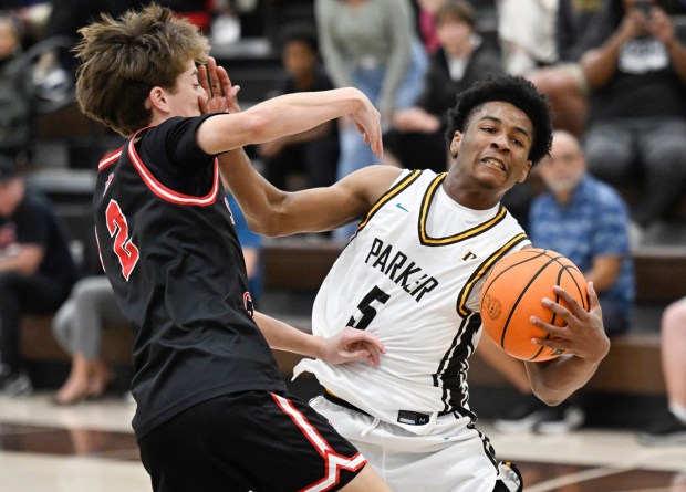 Francis Parker's Columbus Palmer (5) fights for the ball with Santa Fe Christian's Caden Doucette during the second half Feb. 4, 2026 in San Diego, Calif. (Photo by Denis Poroy)