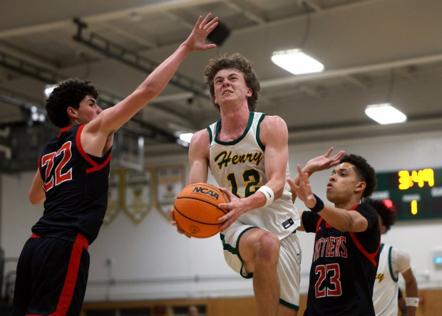 SAN DIEGO, CA - February 10, 2026: Patrick Henry's Isaac Weatherred goes in between Canyon Hills' Slade Stevens, left, and Nehemiah Miller as he attempts a shot in the first half at Patrick Henry High School in San Diego on Tuesday, February 10, 2026. (Hayne Palmour IV / For The San Diego Union-Tribune)