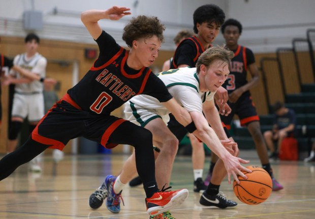 SAN DIEGO, CA - February 10, 2026: Canyon Hills' Anthony Ojeda Jr. left, and Patrick Henry's Madin Gardini chase a loose ball late in the second half at Patrick Henry High School in San Diego on Tuesday, February 10, 2026. (Hayne Palmour IV / For The San Diego Union-Tribune)