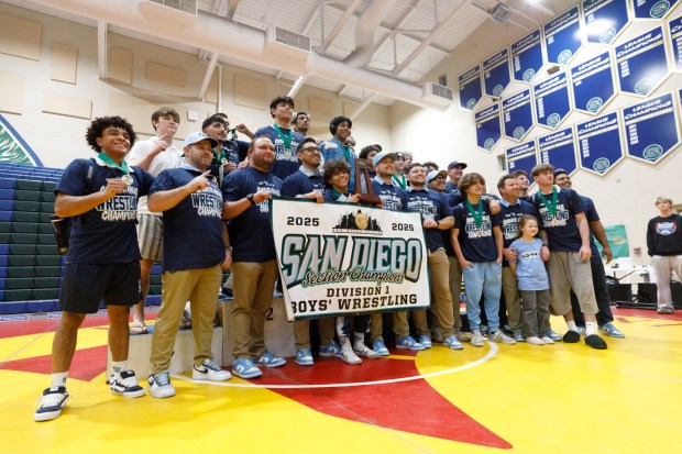 Emilio Escobar, holding the trophy, poses with his team, during the CIF San Diego Division 1 championship meet at Del Norte High School on Saturday, Feb. 14, 2026. (Kristian Carreon / The San Diego Union-Tribune)