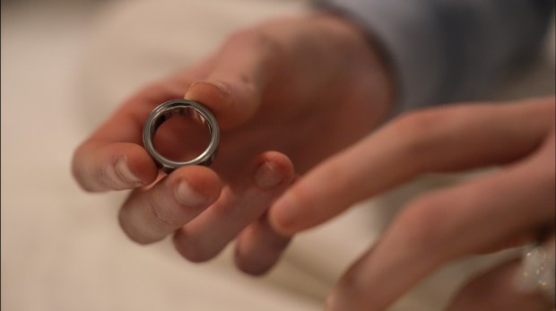 Stoye puts on her Oura Ring, a wearable sleep tracking device. (Emilie Megnien / The Associated Press)
