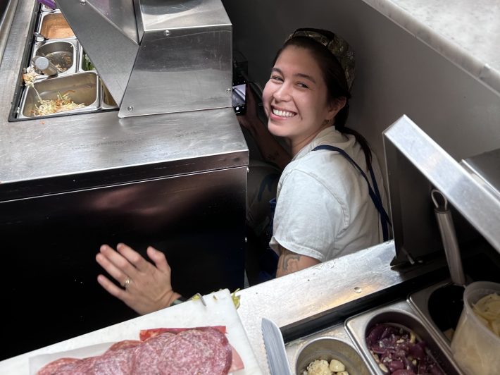 a woman posing in a professional kitchen