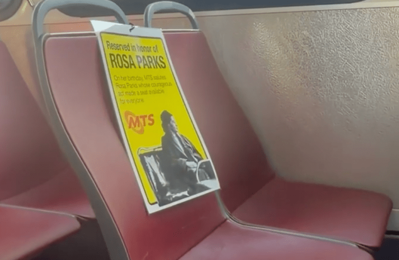 A sign showing a seat has been "reserved" for Rosa Parks on MTS's Transit Equity Day. (Image by Adrian Childress/Times of San Diego)