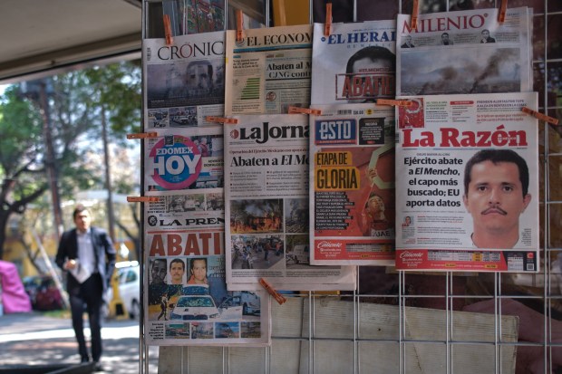 Newspapers hang on display for sale in Mexico City, Monday, Feb. 23, 2026, a day after the Mexican army killed Jalisco New Generation Cartel leader Nemesio Oseguera Cervantes, known as "El Mencho." (AP Photo/Jon Orbach)