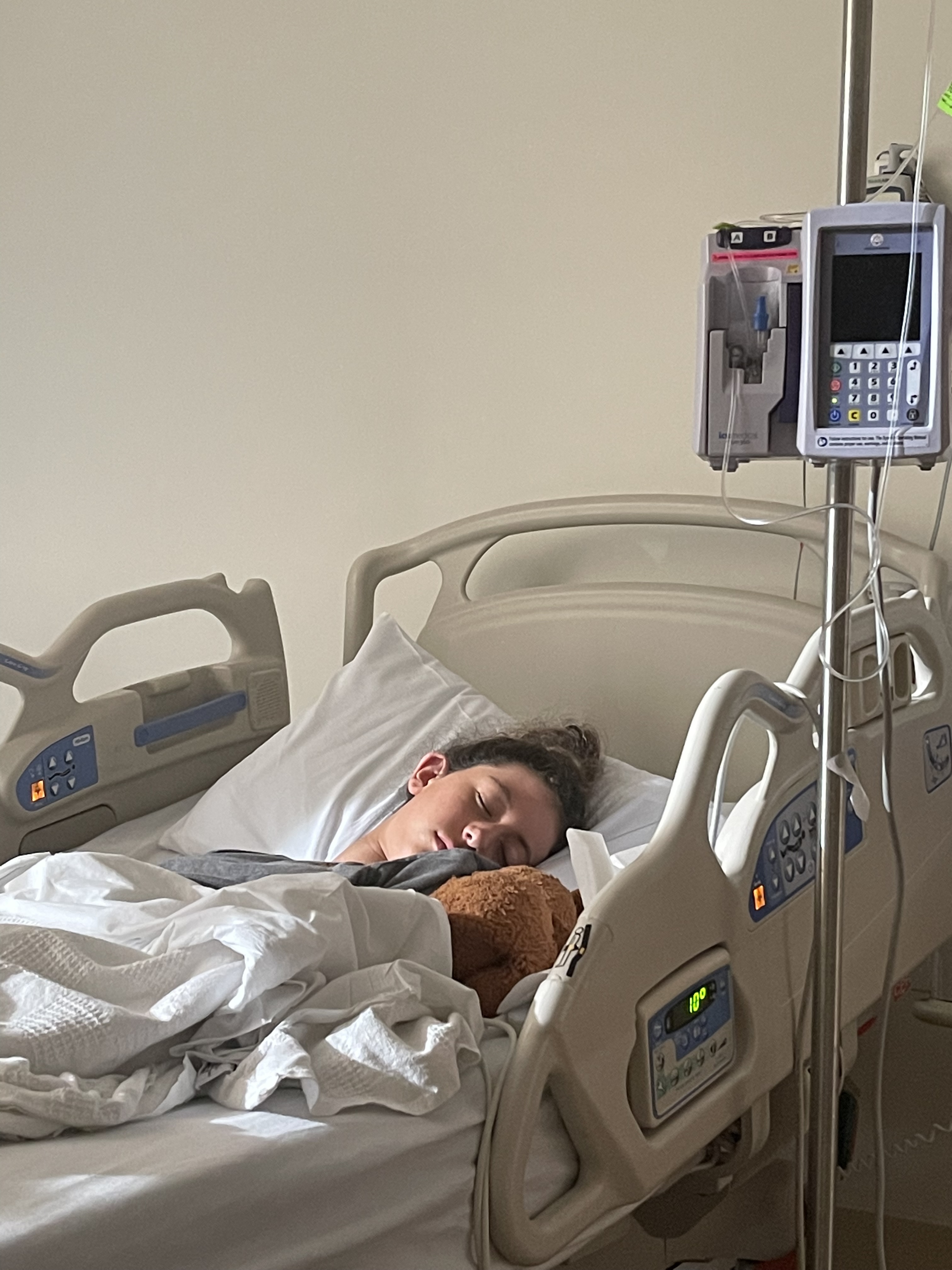 Darya Raker sleeps during her first hospitalization, for severe headaches,...