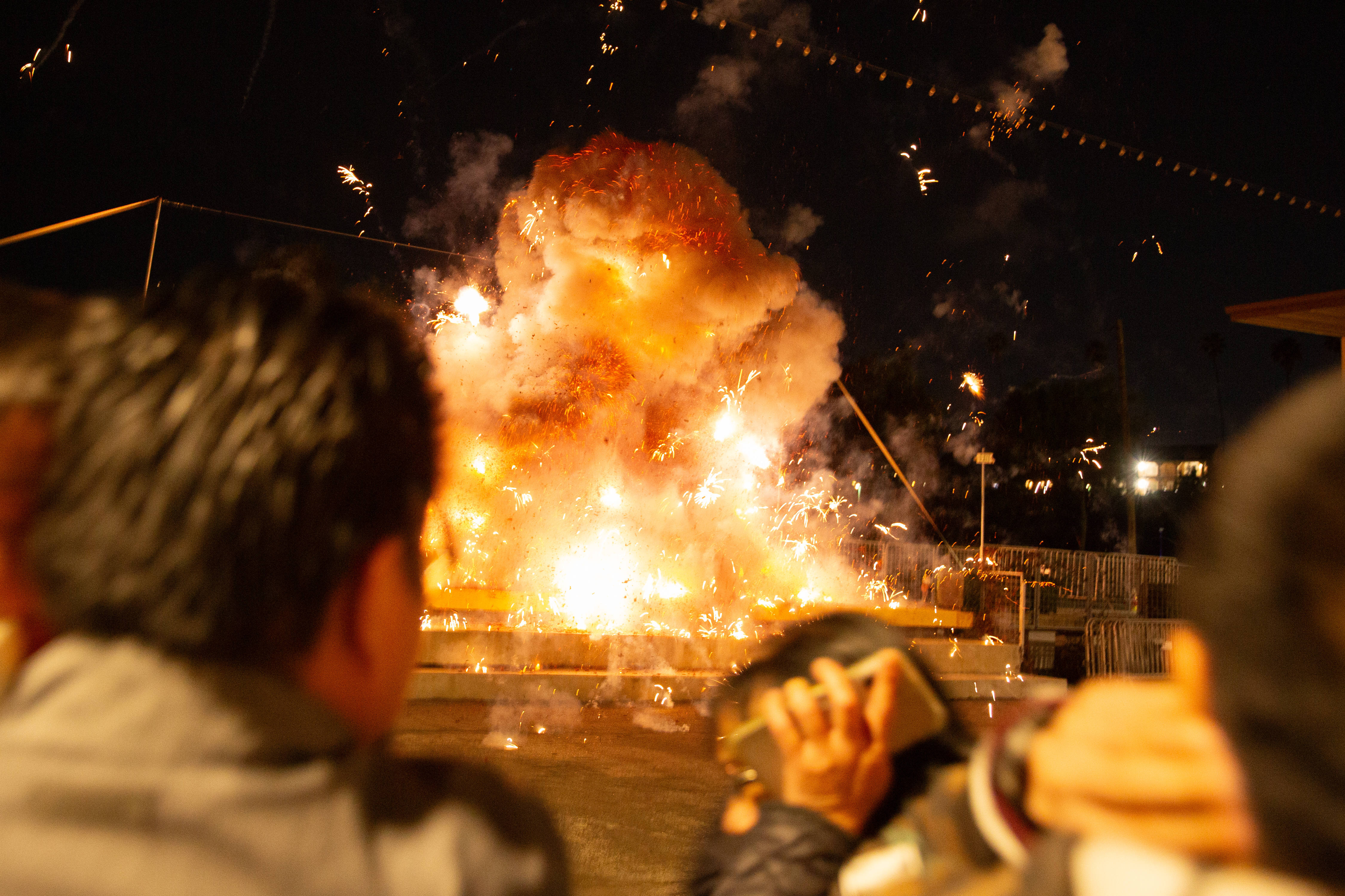 A woman covers her ears as four hanging lines of...