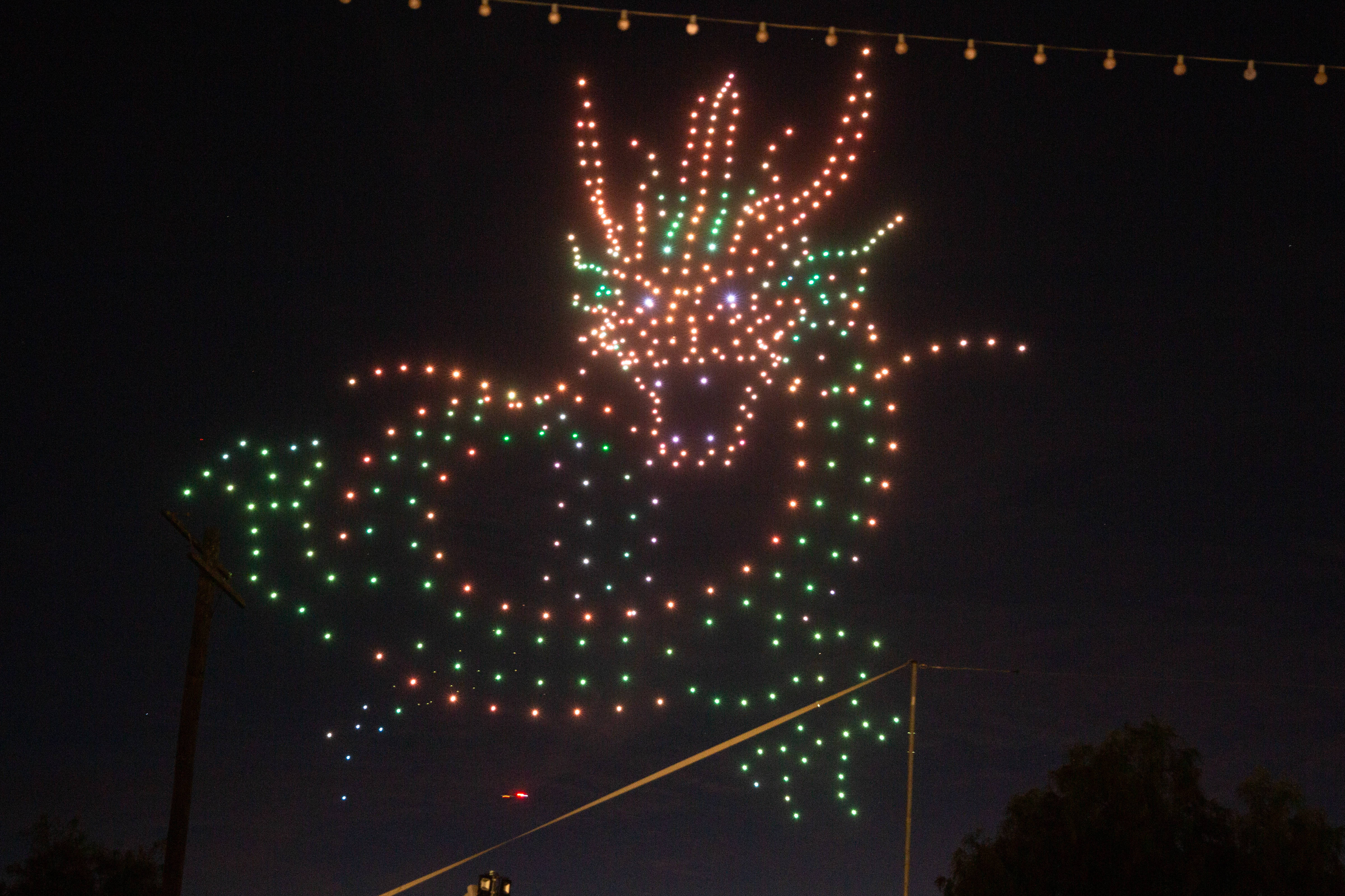 A dragon lights up the sky during a drone show...