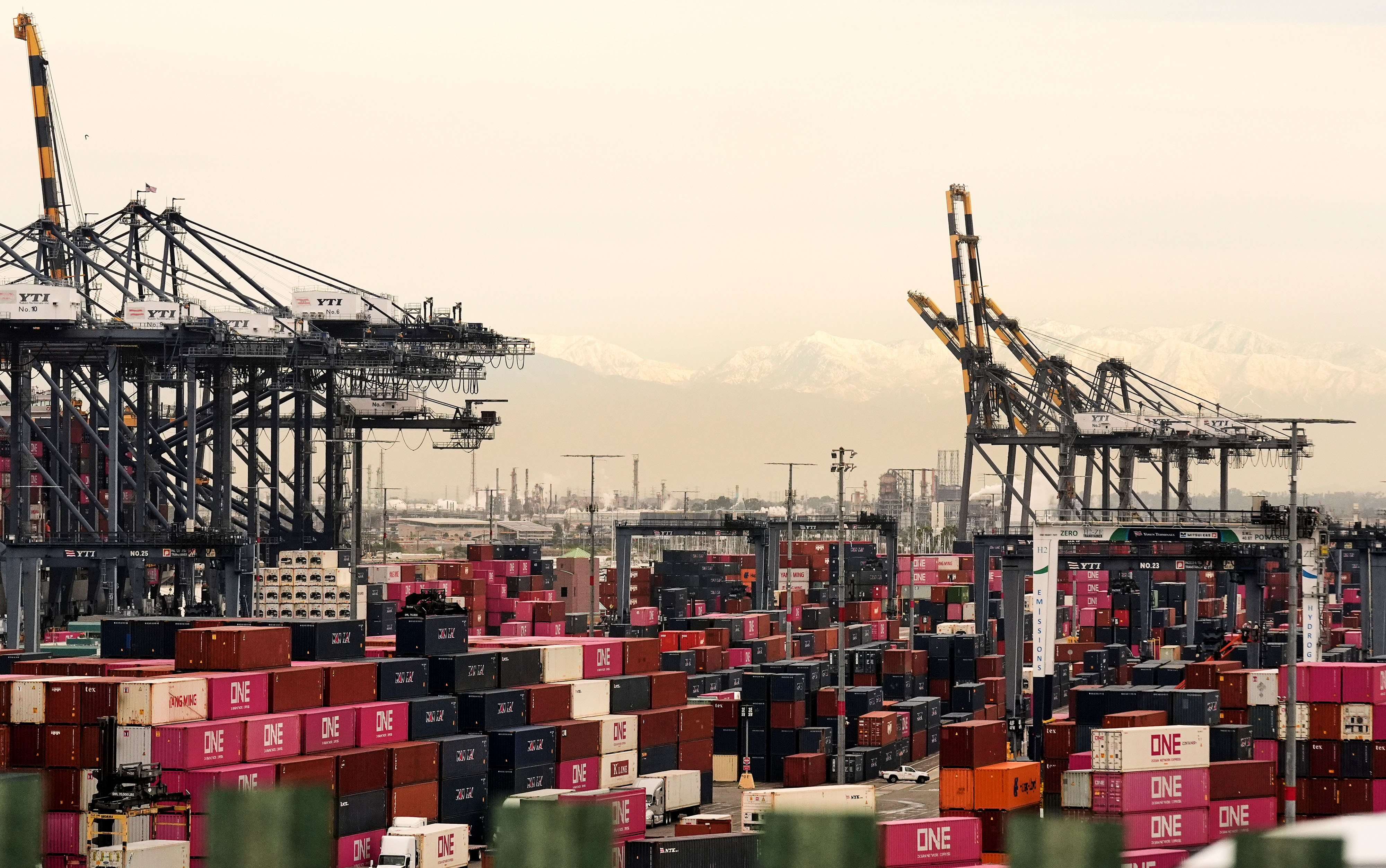 Containers are stacked at the Port of Los Angeles Friday,...