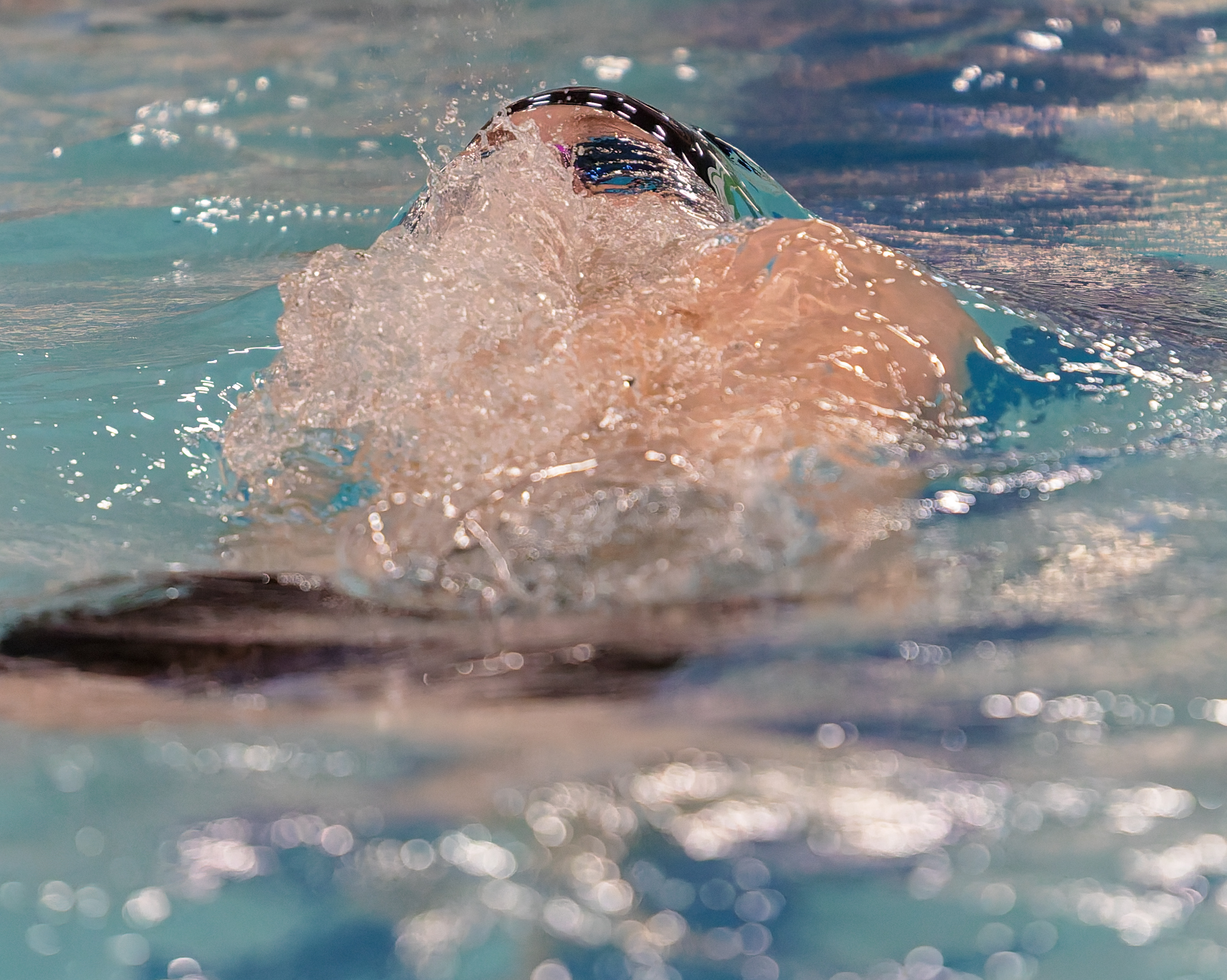 Bloomfield Hills Miles Marx swims in the 100-yard butterfly at...