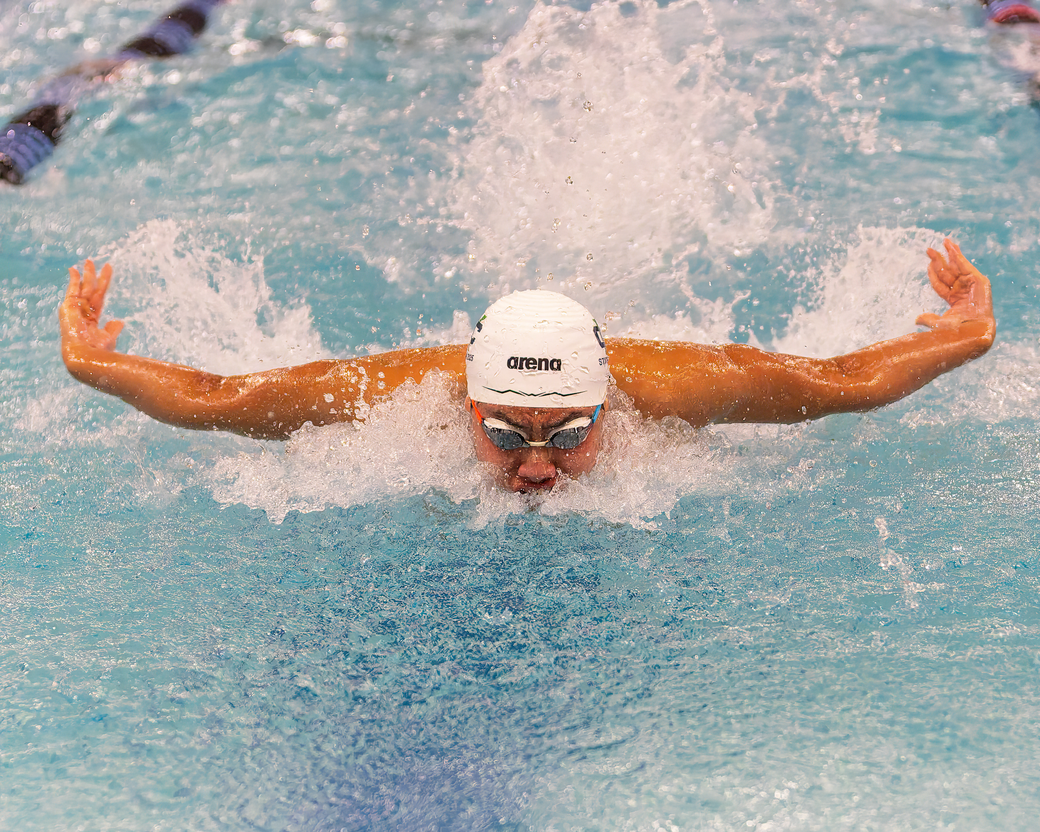 Cranbrook-Kingswood's Ethan Xu swims in the 100-yard butterfly at the...