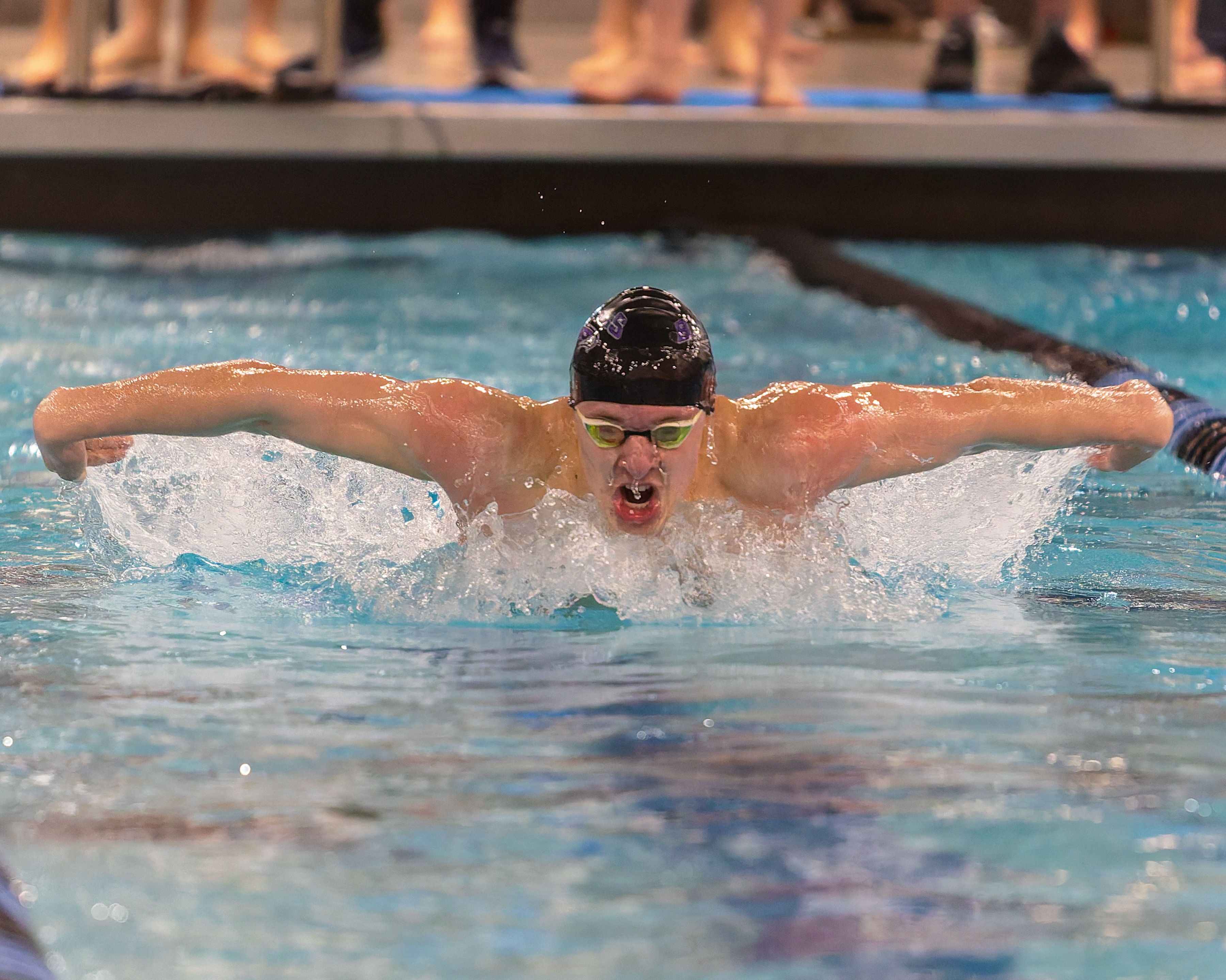 Bloomfield Hills' Miles Marx swims in the 100-yard butterfly at...
