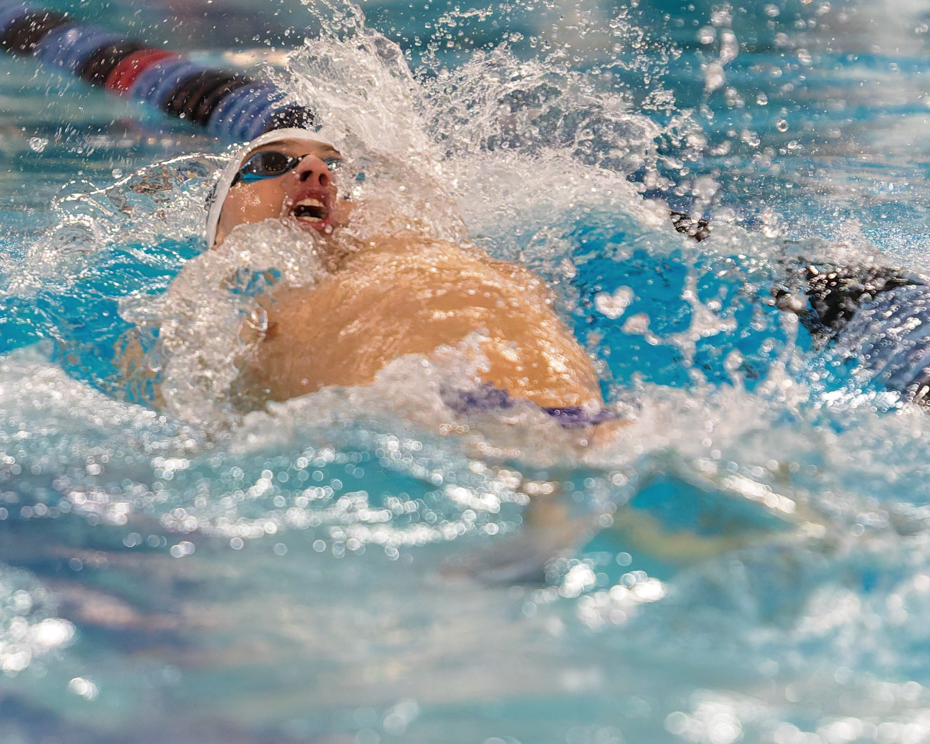 Milford/Lakeland's Sam Campbell swims in the 100-yard backstroke at the...
