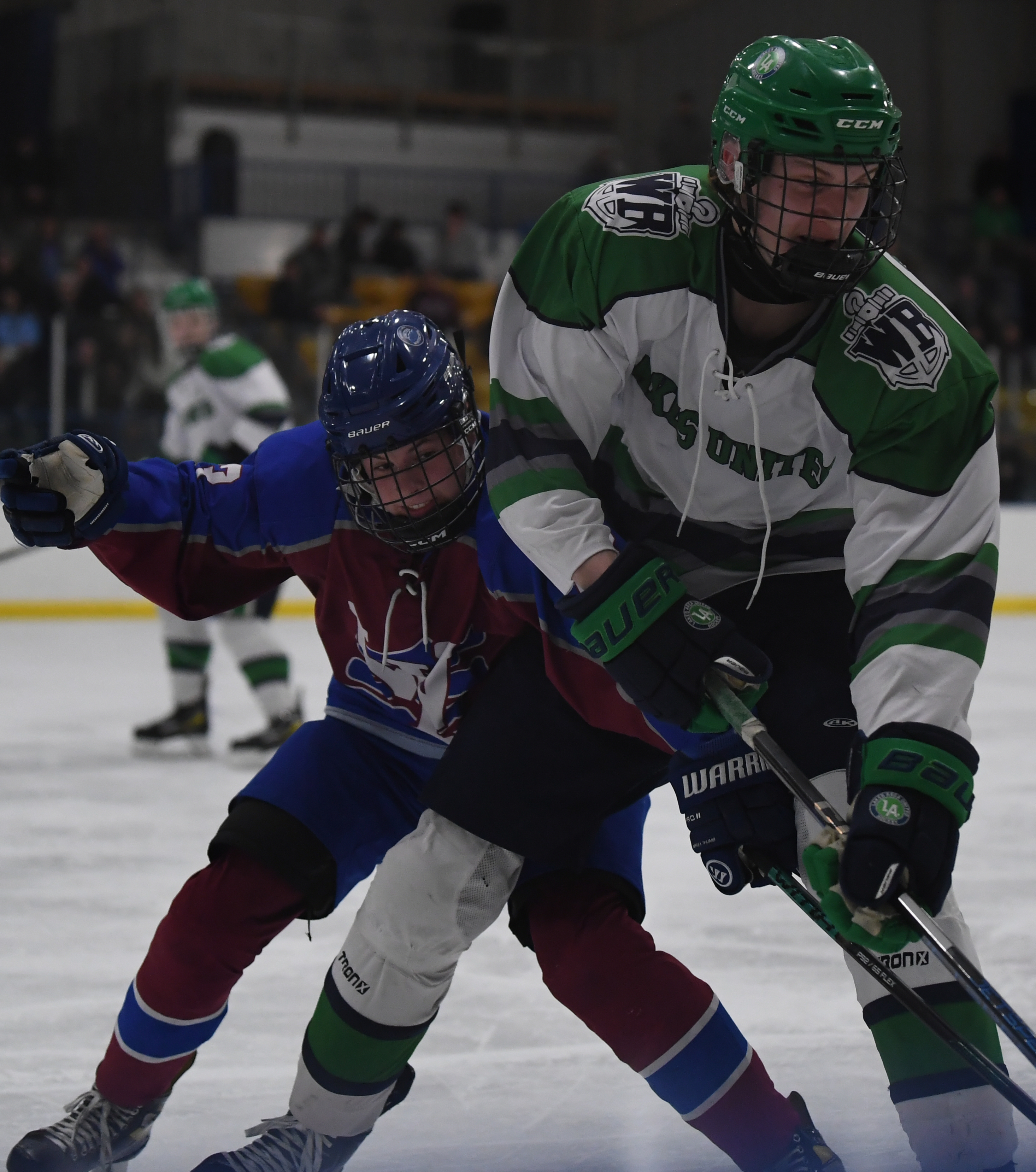 Lakes Area United's Zach Boisvenu (R) protects the puck from...