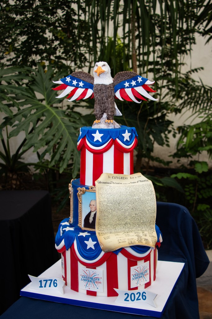 Patriotic cake with a bald eagle, Declaration of Independence, and USA-themed decorations.