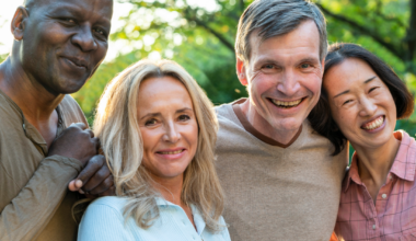 Four older adults smiling
