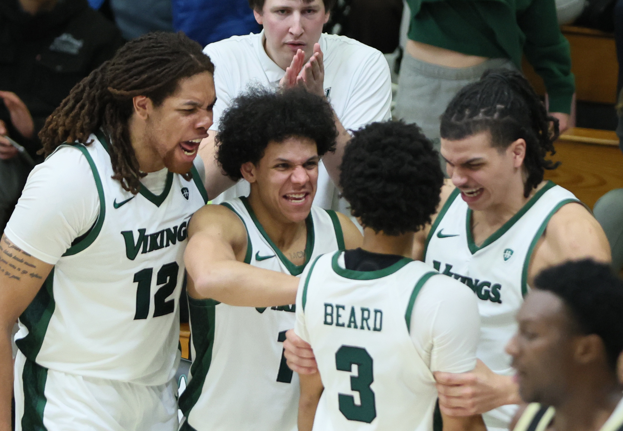 Cleveland State Vikings bench celebrates the three-point score by Cleveland State Vikings guard Tre Beard in the second half.  