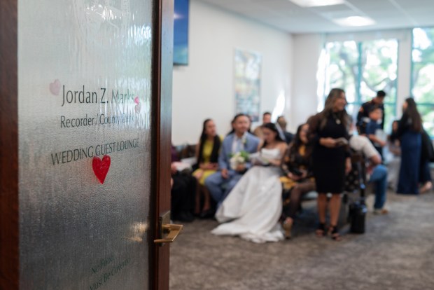 Couples and their guests wait for their civil ceremonies at the County Clerk's office inside the San Diego County Administration Center on Valentine's Day, Feb. 14, 2026. (McKenzie Patterson / For The San Diego Union-Tribune)