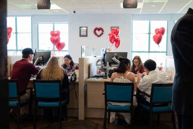 Couples meet with staff inside the San Diego County Administration Center to complete paperwork for civil wedding ceremonies on Valentine's Day, Feb. 14, 2026. (McKenzie Patterson / For The San Diego Union-Tribune)