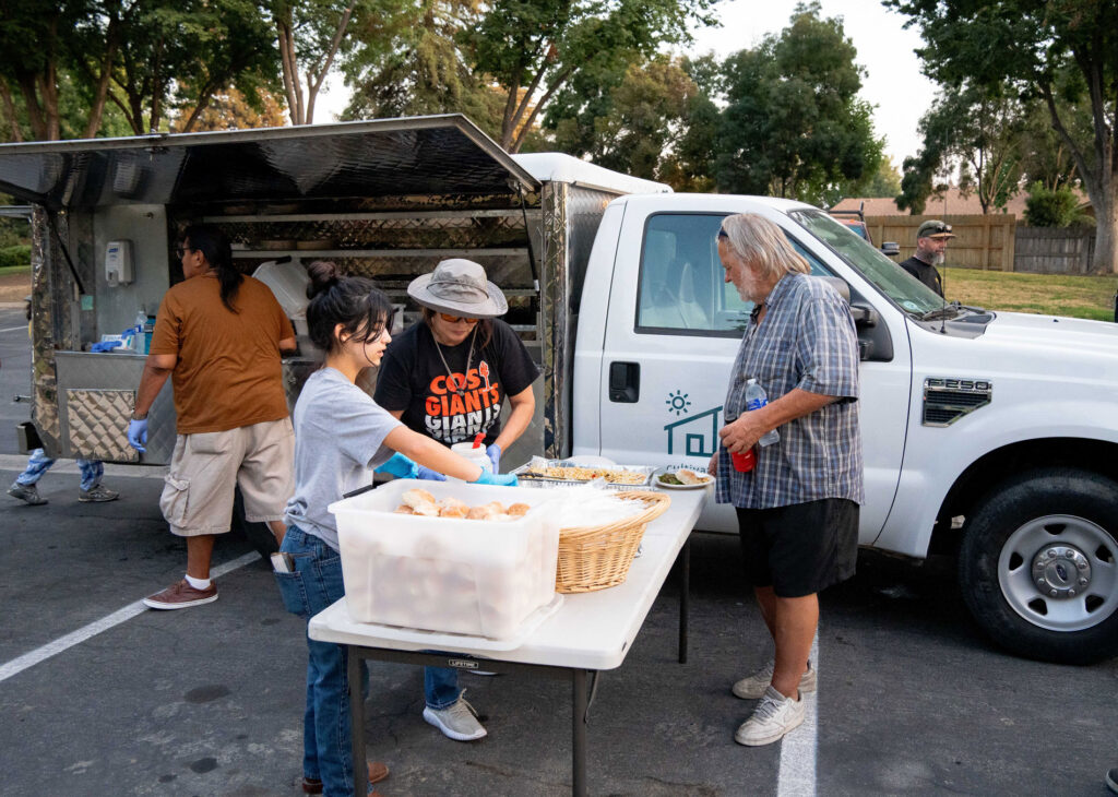 Folks set up the food truck operation.