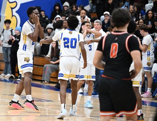 Wood's Jayden Lennitte and Josyah Ebuen give the 'night-night' sign as the Wildcats defeated their cross-town rival, Vacaville, 47-39 on Thursday. (Chris Riley/The Reporter)