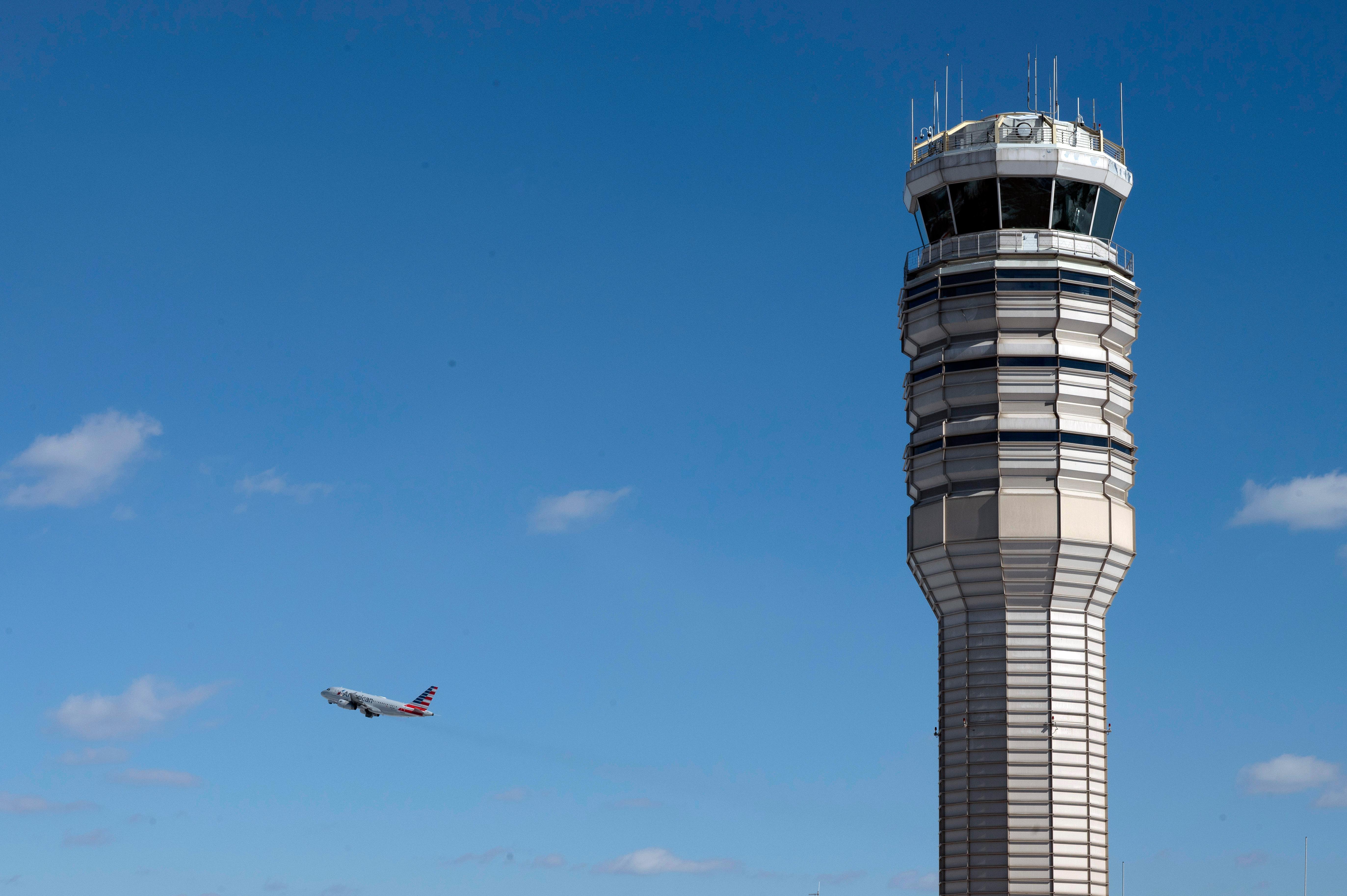An airplane takes off behind the control tower at Ronald...