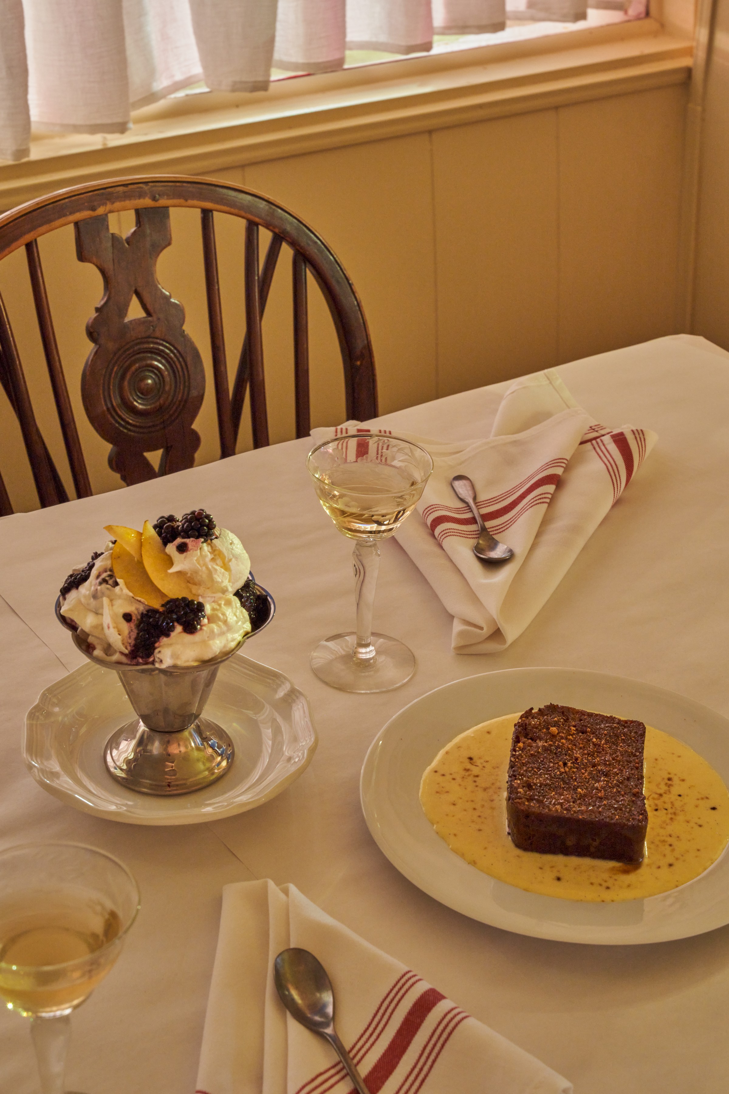 Eton mess and sticky toffee pudding on a white table at Wilde’s
