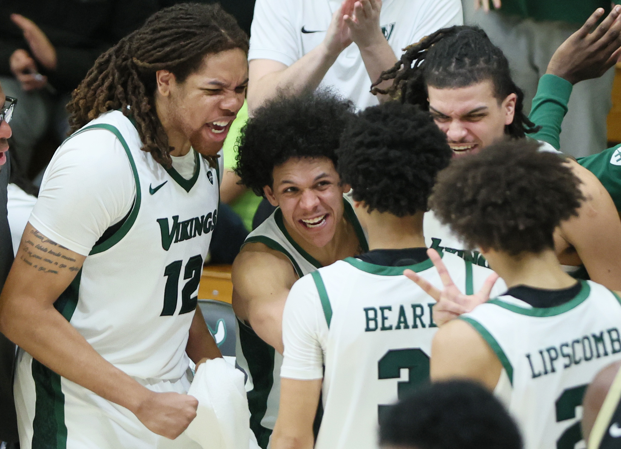 Cleveland State Vikings bench celebrates the three-point score by Cleveland State Vikings guard Tre Beard in the second half.  