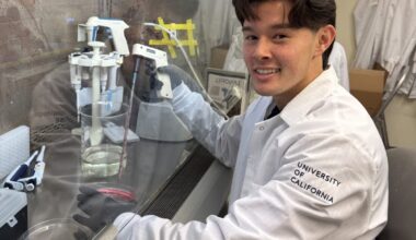 man in lab coat doing experiment