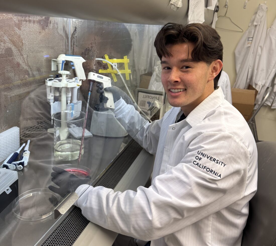 man in lab coat doing experiment