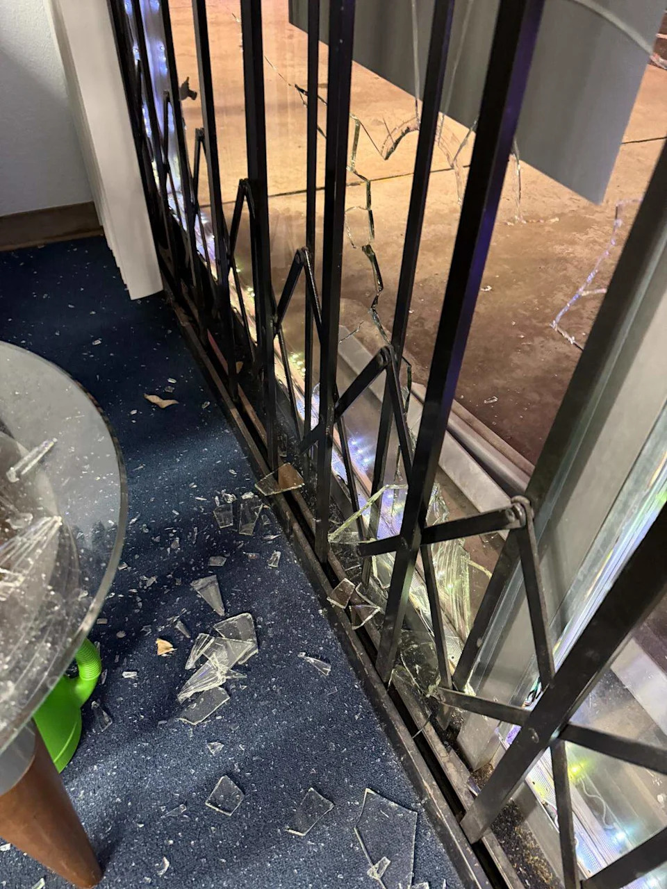 A window at Cell Tech was broken after debris struck it after a vehicle went airborne on Wednesday, Feb. 18, 2026.