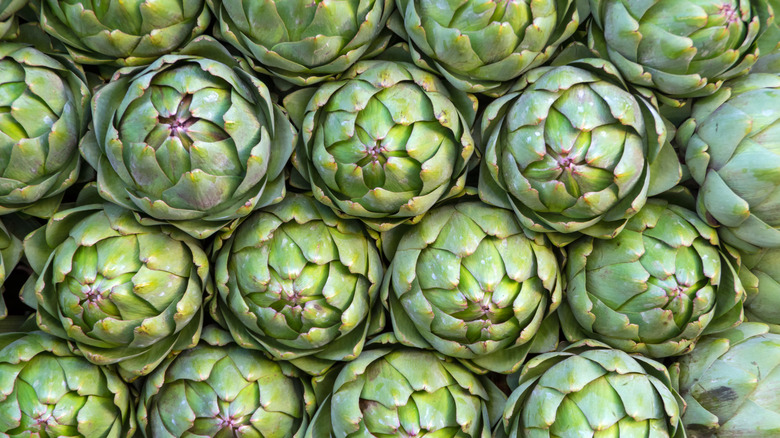A bunch of fresh, raw artichokes