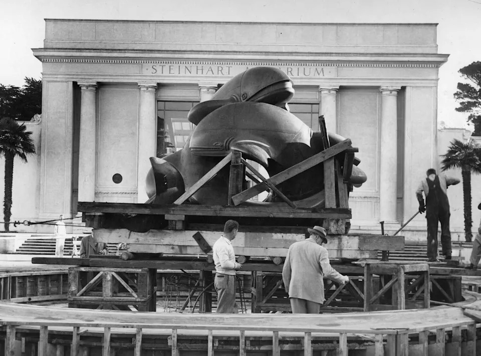 1956: Workers install Robert Howard's "Whales" sculpture outside Steinhart Aquarium at the California Academy of Sciences building in Golden Gate Park. (Bob Campbell/S.F. Chronicle)