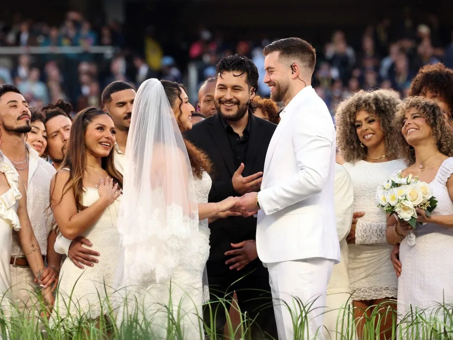 SANTA CLARA, CALIFORNIA – FEBRUARY 08: A couple marries during the Bad Bunny performance onstage during the Apple Music Super Bowl LX Halftime Show at Levi’s Stadium on February 08, 2026 in Santa Clara, California. (Photo by Kevin Mazur/Getty Images for Roc Nation)