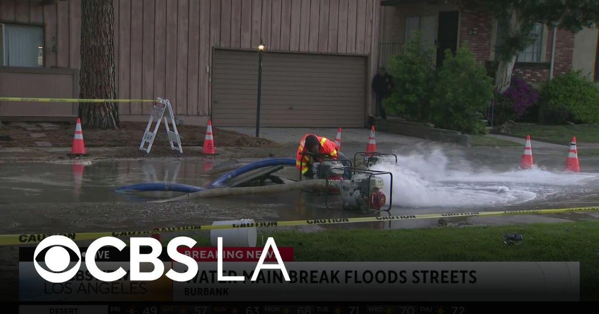 Burbank water main break traps a vehicle and damages street