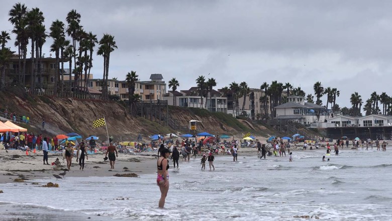 Beachgoers gather north of Crystal Pier in Pacific Beach. Photo by Chris Stone
