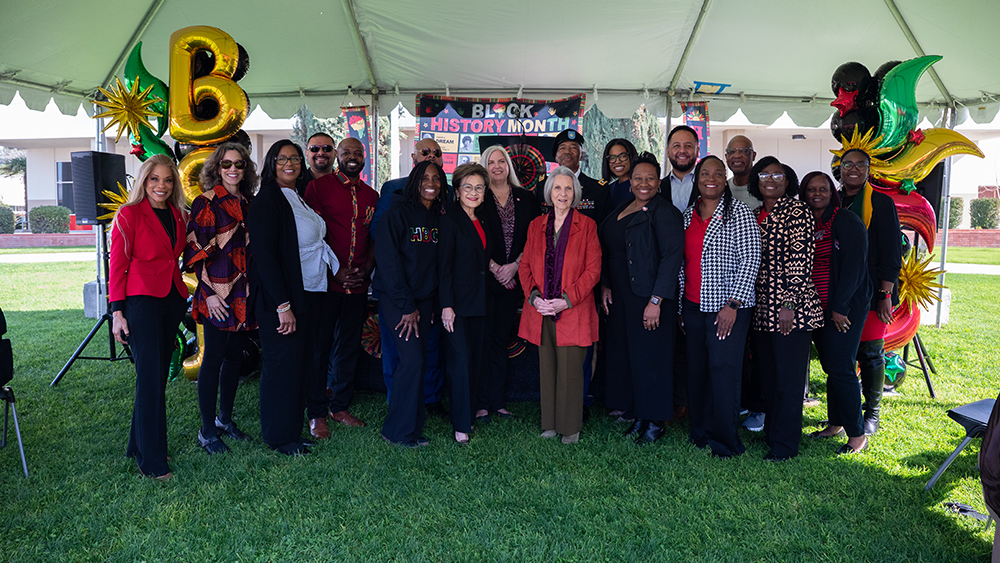 Event speakers and BC administration posing together under event tent