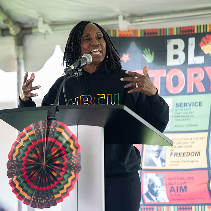 African American female speaking from a podium
