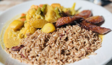 A plate of Jamaican rice and peas with vegetable curry.