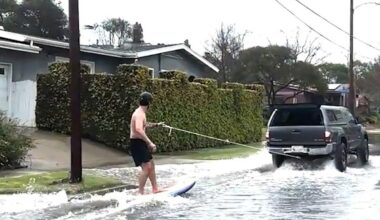 Surfer spotted catching waves on SoCal street during mass flooding