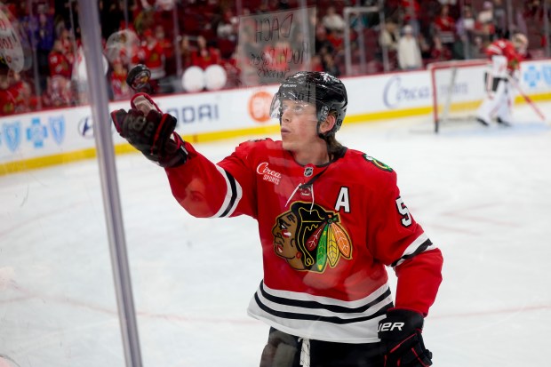 Chicago Blackhawks defenseman Connor Murphy (5) tosses a puck into the stands before the first period against the San Jose Sharks at the United Center Monday Feb. 2, 2026 in Chicago. (Armando L. Sanchez/Chicago Tribune)