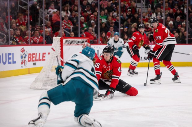 San Jose Sharks center Will Smith (2) scores a goal past Chicago Blackhawks defenseman Louis Crevier (46) and Chicago Blackhawks goaltender Spencer Knight (30) during the second period at the United Center Monday Feb. 2, 2026 in Chicago. (Armando L. Sanchez/Chicago Tribune)