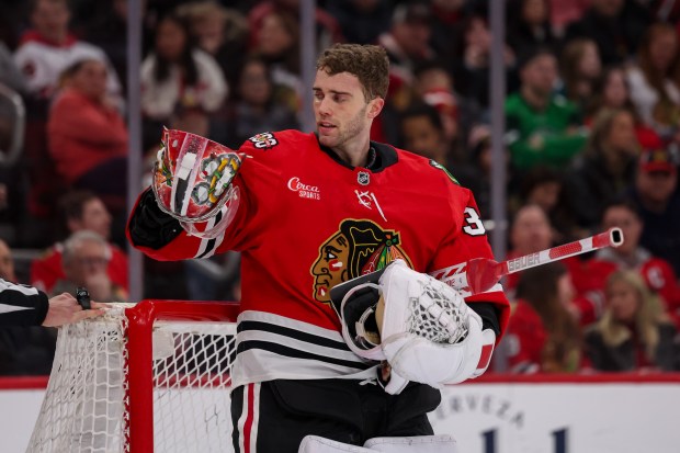 Chicago Blackhawks goaltender Spencer Knight (30) adjusts his helmet during the second period against the San Jose Sharks at the United Center Monday Feb. 2, 2026 in Chicago. (Armando L. Sanchez/Chicago Tribune)