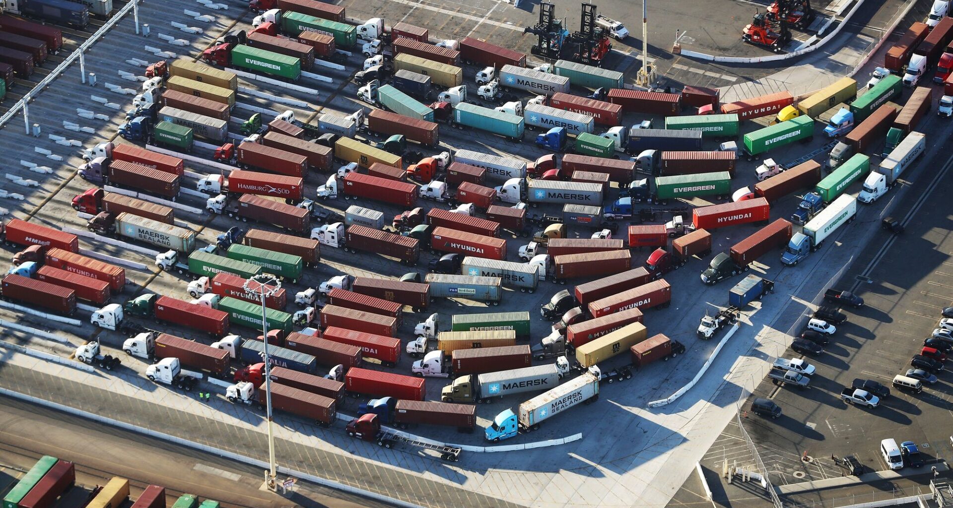 An aerial view of shipping containers attached to trucks