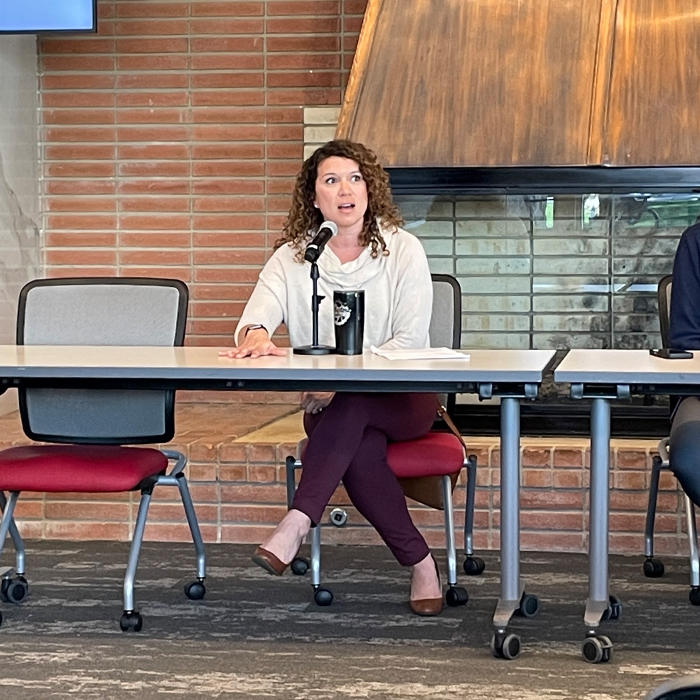 female talking into a microphone