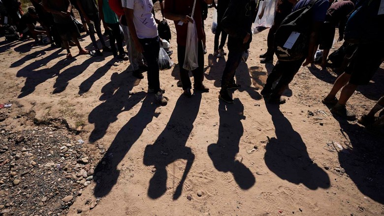 FILE - Migrants wait to be processed by the U.S. Customs and Border Patrol after they crossed the Rio Grande and entered the U.S. from Mexico, on Oct. 19, 2023, in Eagle Pass, Texas. (File photo courtesy Associated Press/Eric Gay)