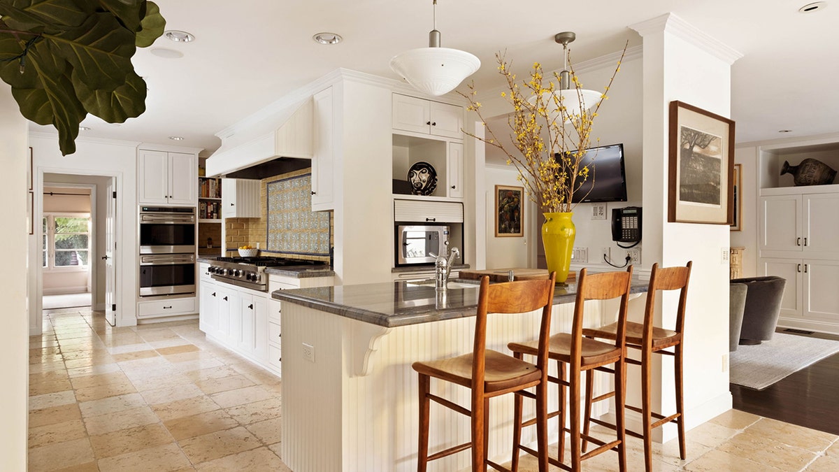 The kitchen features an eat-in island and a double oven.