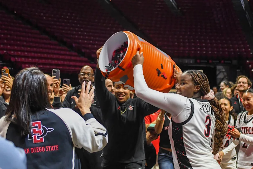SDSU Aztecs celebrate winning the Mountain West Championships during an NCAA Women’s Basketball game against Fresno State Saturday February 21, 2026 in San Diego, California.