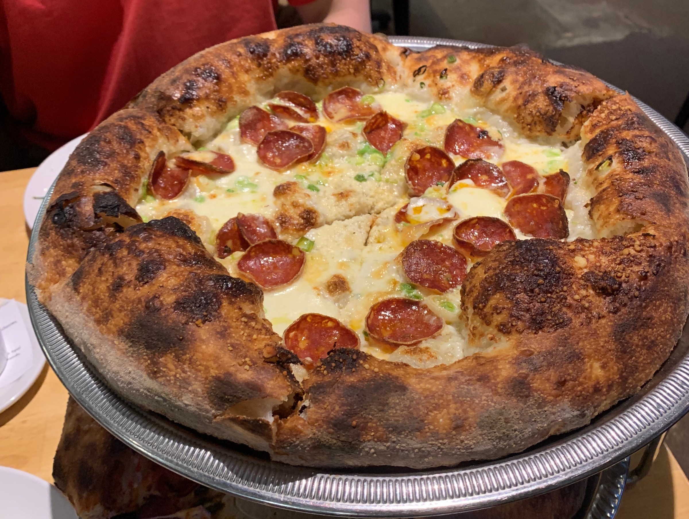 Fluffy pizza crust white pizza with pepperonis and scallions at Folks Pizzeria in Costa Mesa.