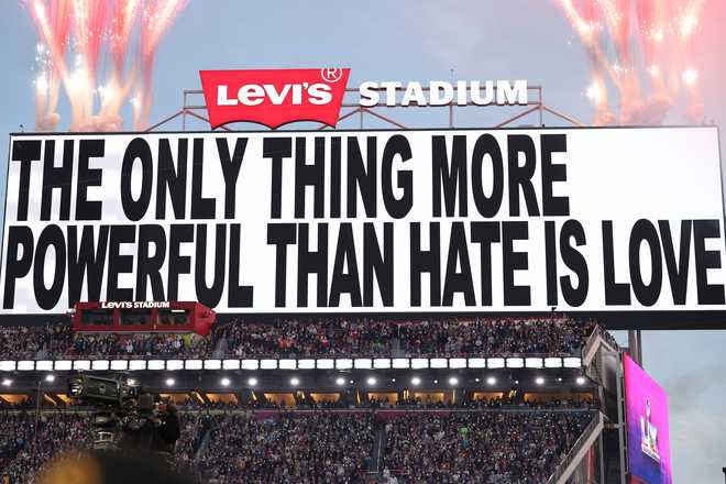 SANTA CLARA, CALIFORNIA - FEBRUARY 08: Signage that reads "The Only Thing More Powerful than Hate is Love" is displayed on the scoreboard during the Apple Music Super Bowl LX Halftime Show at Levi's Stadium on February 08, 2026 in Santa Clara, California. (Photo by Kevin C. Cox/Getty Images)